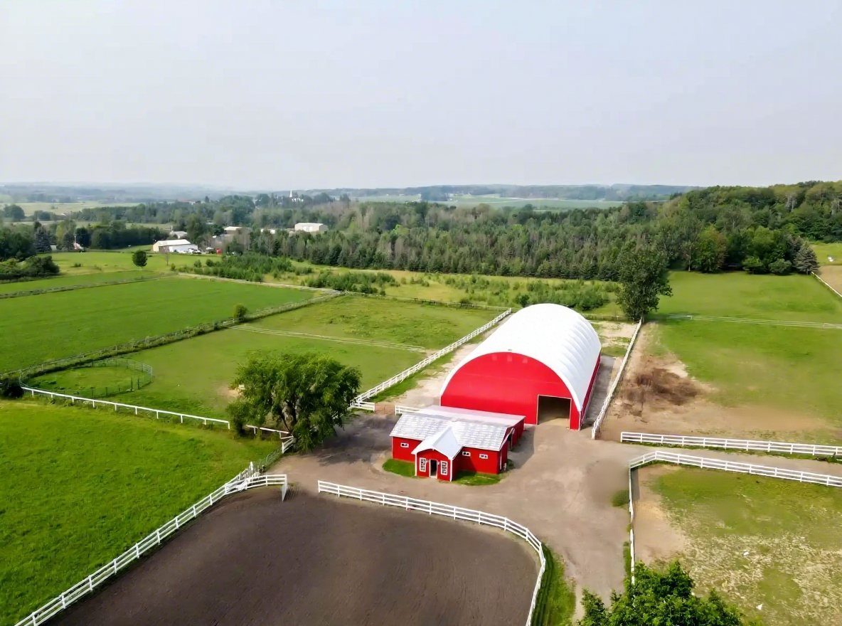 Aerial red riding arena and stable complex