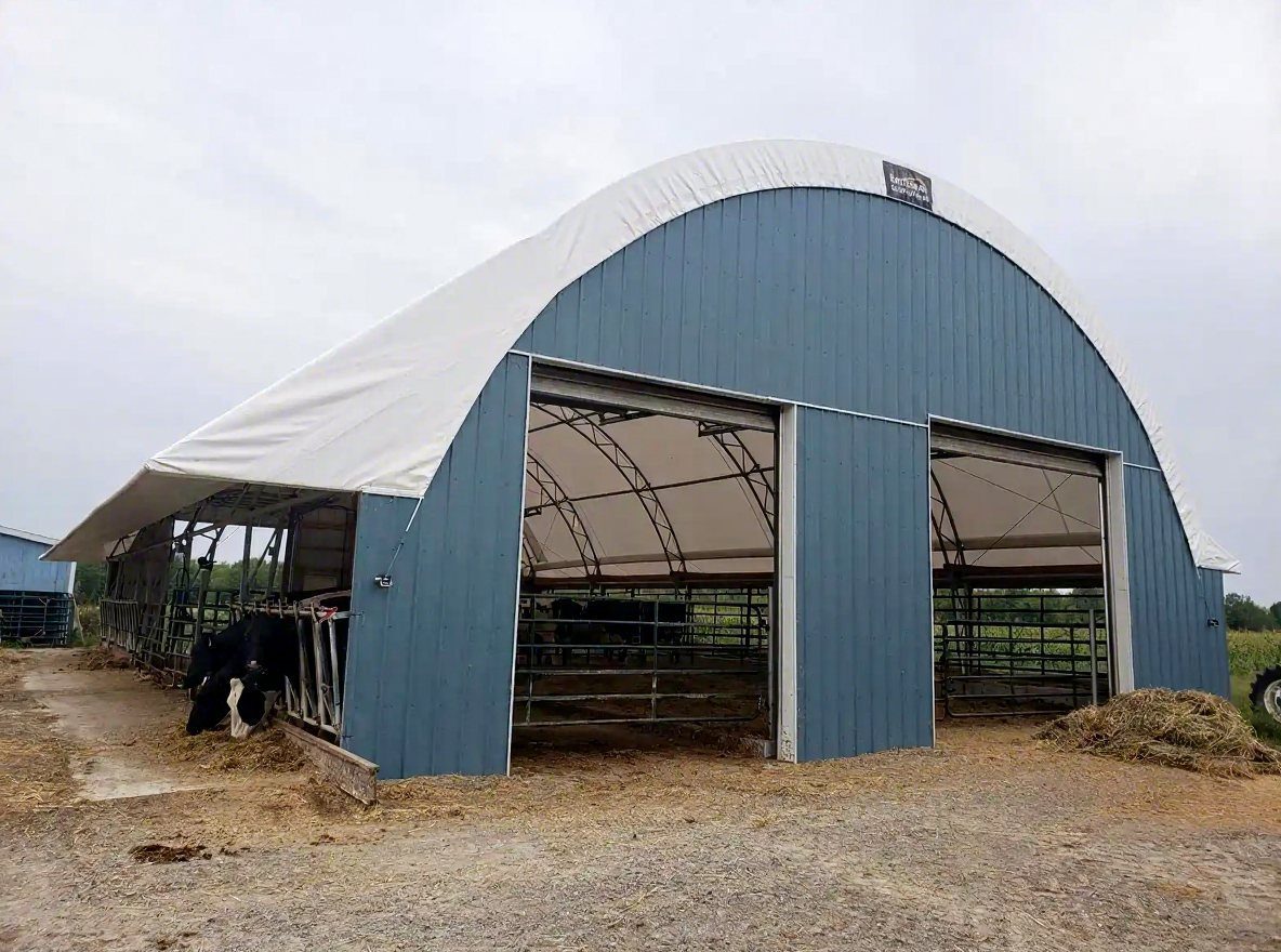 Blue livestock barn with fabric roof